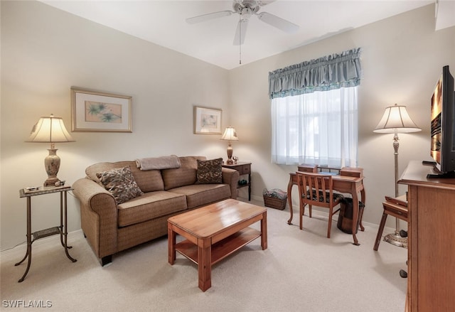 living room with baseboards, light colored carpet, and ceiling fan