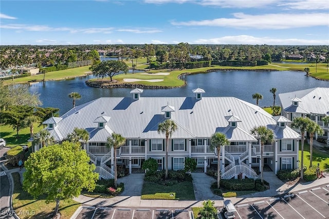 birds eye view of property featuring view of golf course and a water view