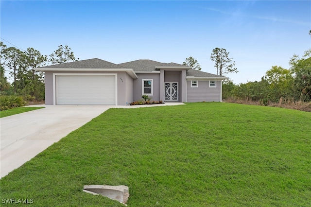 prairie-style home with an attached garage, a front lawn, concrete driveway, and stucco siding