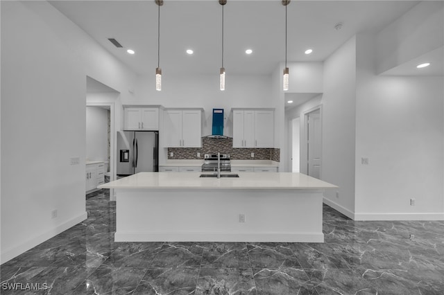 kitchen with stainless steel appliances, a sink, visible vents, marble finish floor, and wall chimney exhaust hood