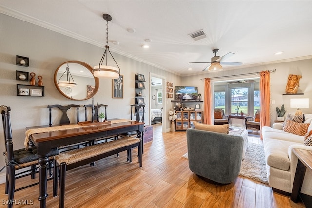 living room featuring visible vents, ceiling fan, ornamental molding, light wood-type flooring, and recessed lighting