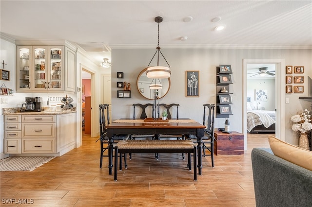 dining space with wood tiled floor and ornamental molding