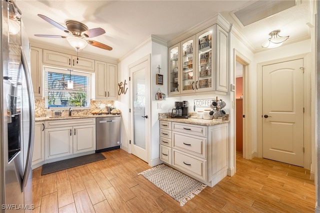 kitchen with appliances with stainless steel finishes, visible vents, ornamental molding, and light wood-style flooring