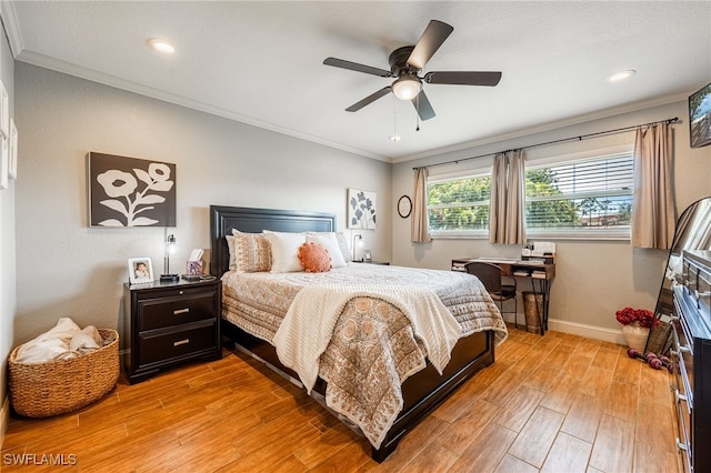 bedroom featuring ornamental molding, light wood finished floors, a ceiling fan, and baseboards