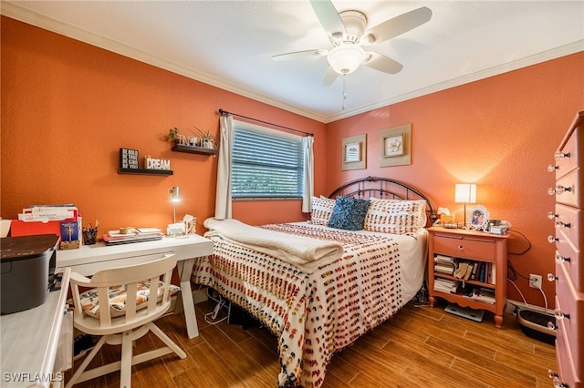 bedroom with a textured wall, wood finish floors, crown molding, and a ceiling fan