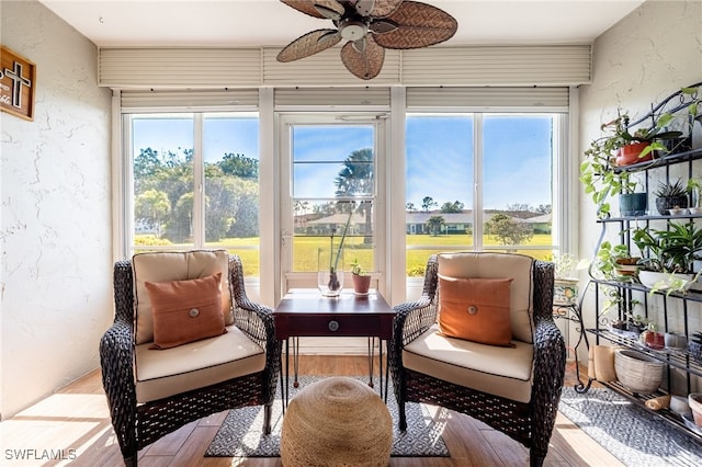 sunroom / solarium featuring ceiling fan