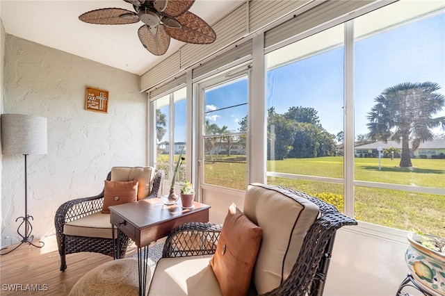 sunroom featuring a ceiling fan