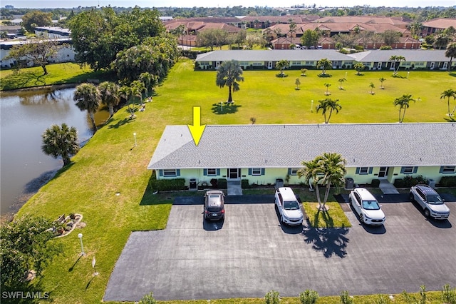 drone / aerial view with a water view and a residential view