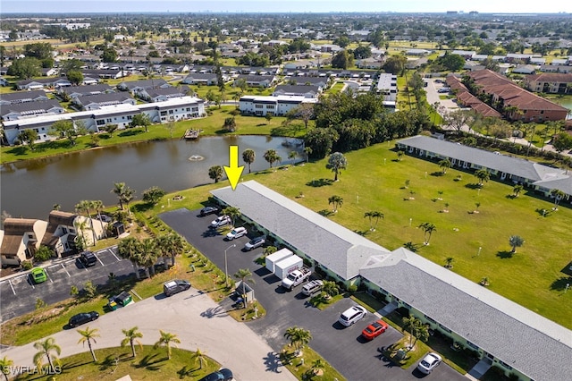 birds eye view of property with a water view and a residential view