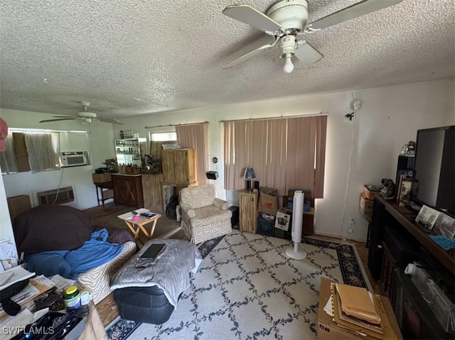 living room featuring ceiling fan, visible vents, and a textured ceiling