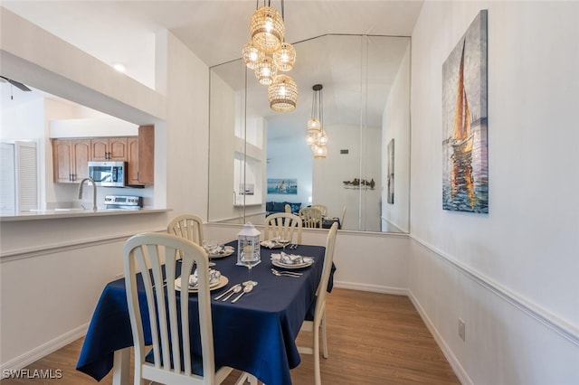 dining room with baseboards and wood finished floors