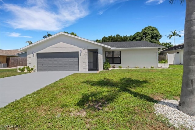 ranch-style home with stucco siding, fence, a garage, driveway, and a front lawn