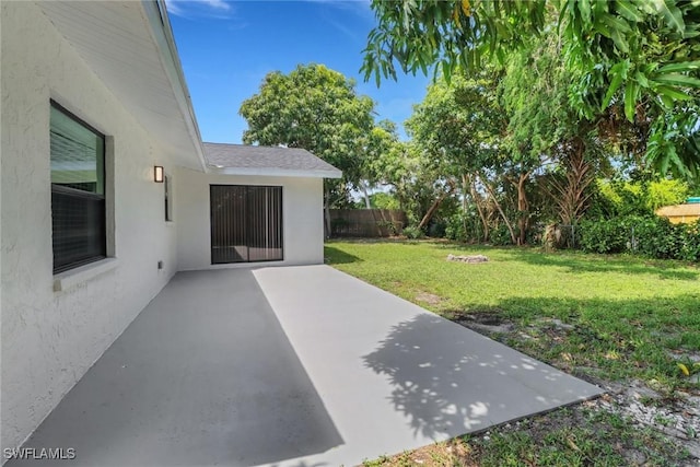 view of yard with fence and a patio