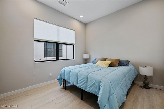 bedroom featuring recessed lighting, visible vents, baseboards, and wood finished floors