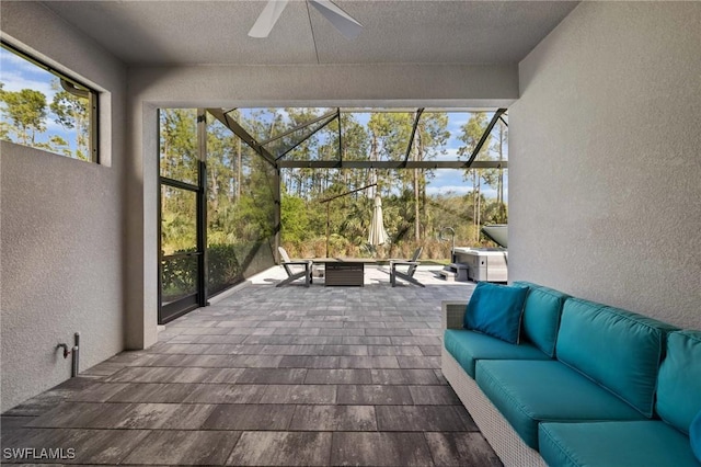 sunroom / solarium with a ceiling fan