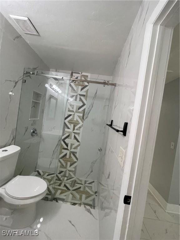 full bath featuring a marble finish shower, visible vents, toilet, and marble finish floor