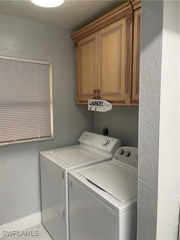 washroom with cabinet space and separate washer and dryer