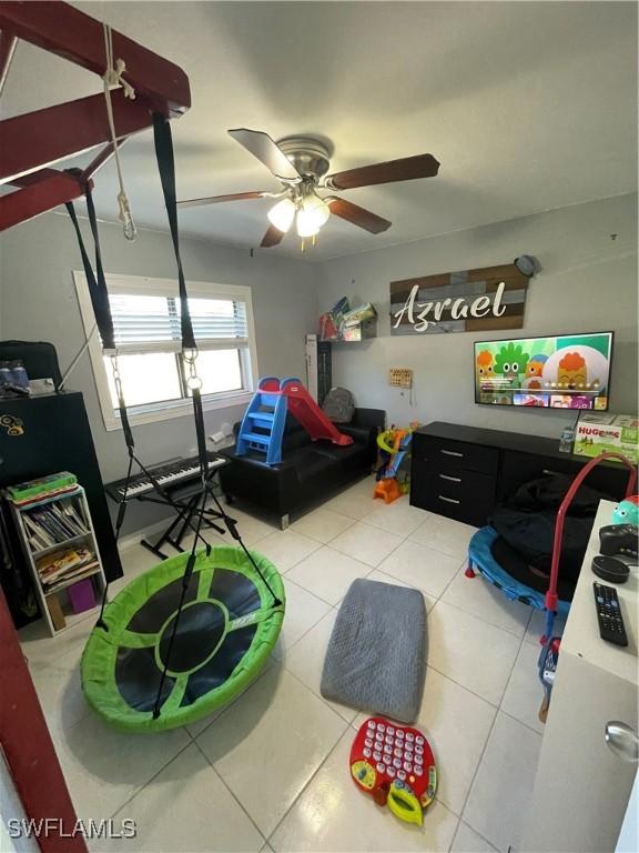 tiled bedroom featuring ceiling fan