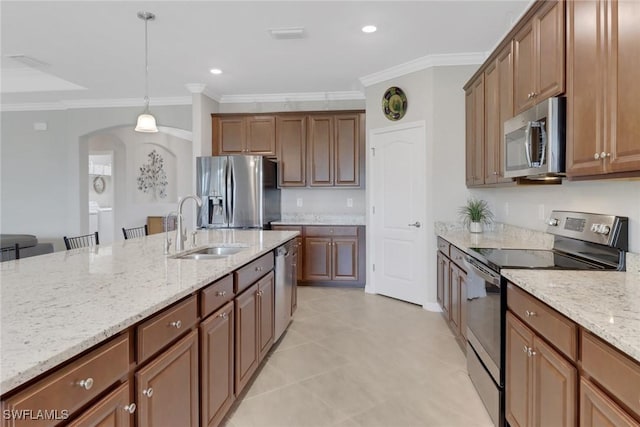 kitchen featuring a sink, light stone countertops, appliances with stainless steel finishes, and crown molding