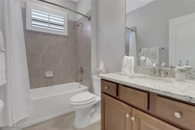 full bath with tile patterned floors, shower / bath combo with shower curtain, toilet, and vanity