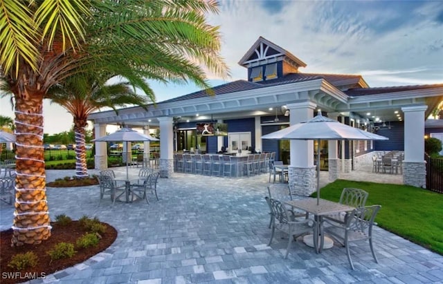 view of patio / terrace featuring a gazebo, outdoor dining area, and outdoor dry bar