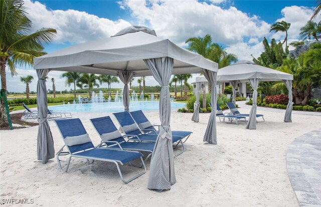 view of community with a gazebo, a patio, and a pool