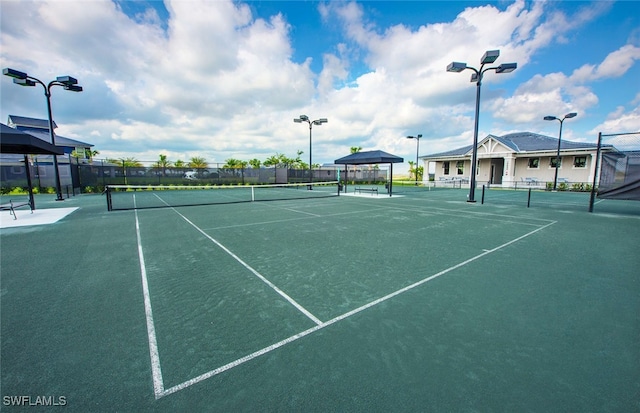 view of tennis court with fence