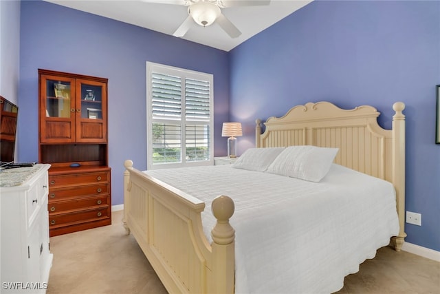 bedroom featuring light tile patterned floors, ceiling fan, and baseboards