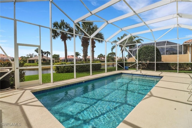 pool with glass enclosure and a patio area