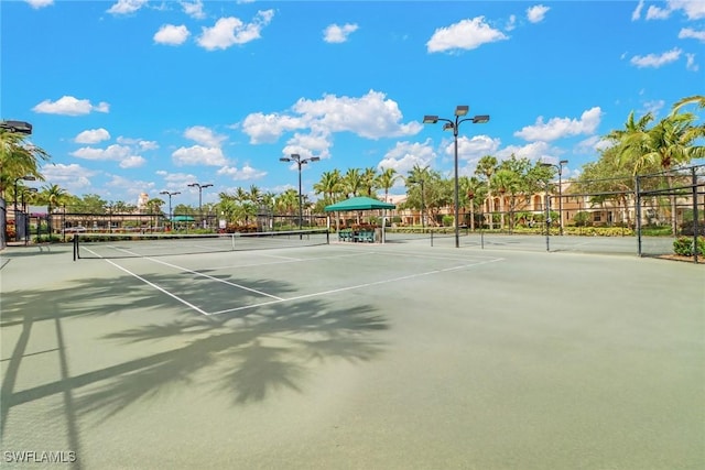 view of tennis court featuring fence