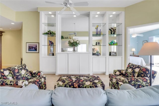 living area featuring ceiling fan, built in features, and recessed lighting