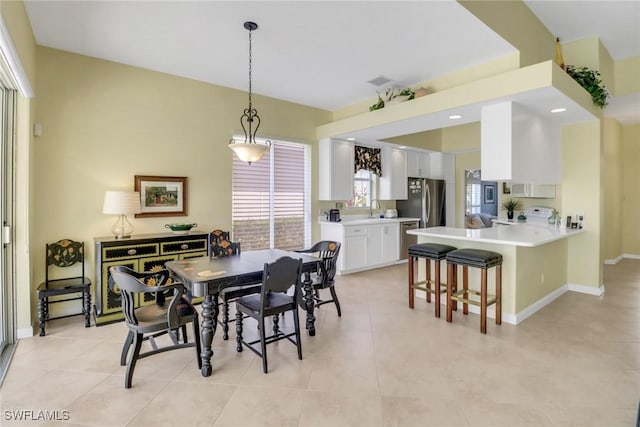 dining room featuring light tile patterned flooring, visible vents, and baseboards