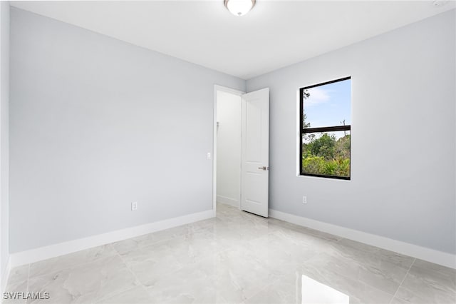 spare room featuring baseboards