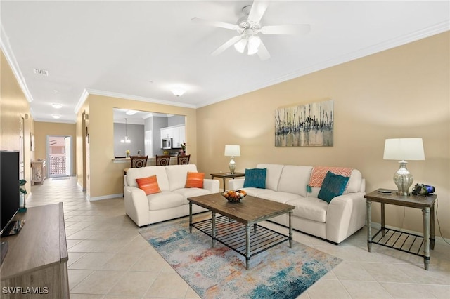 living area featuring light tile patterned floors, visible vents, baseboards, and crown molding