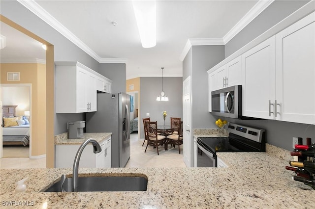 kitchen featuring white cabinetry, appliances with stainless steel finishes, light stone counters, and a sink