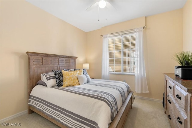 bedroom featuring light colored carpet, ceiling fan, and baseboards