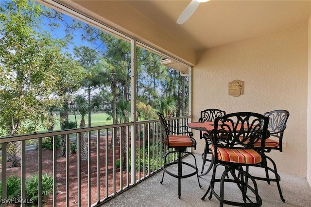 sunroom / solarium featuring ceiling fan