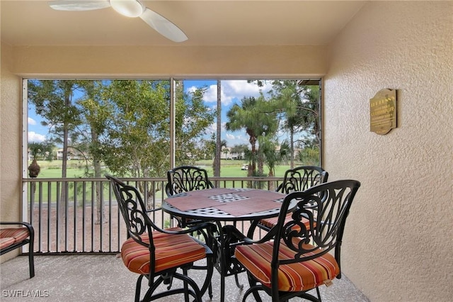 sunroom featuring a ceiling fan