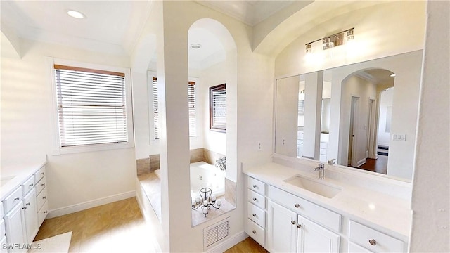 bathroom featuring visible vents, a jetted tub, recessed lighting, baseboards, and vanity