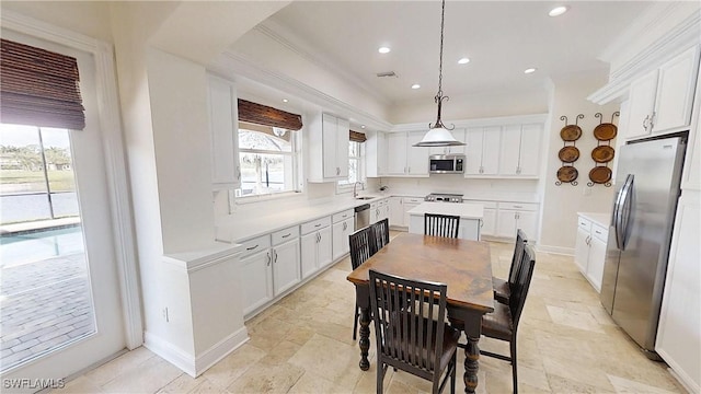 kitchen with appliances with stainless steel finishes, white cabinetry, and a sink