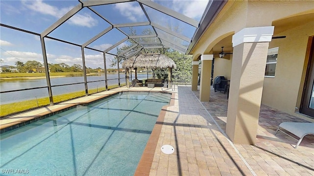 outdoor pool with a water view, a patio, and a lanai