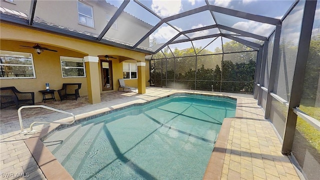 pool with a patio area, a lanai, and a ceiling fan