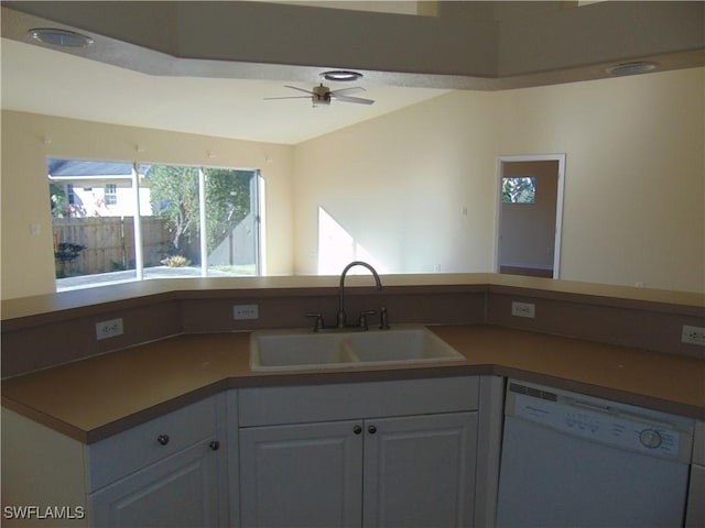 kitchen featuring a sink, a ceiling fan, white cabinets, dishwasher, and dark countertops