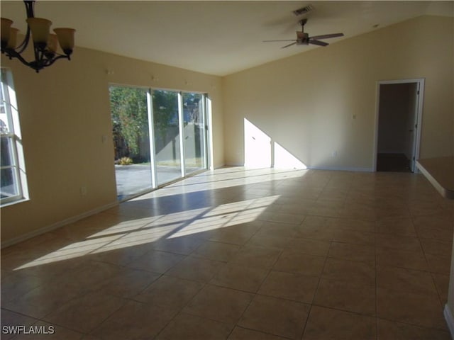 tiled spare room with visible vents, vaulted ceiling, baseboards, and ceiling fan with notable chandelier