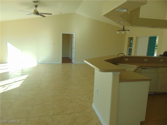 kitchen with dishwasher, vaulted ceiling, open floor plan, and a sink