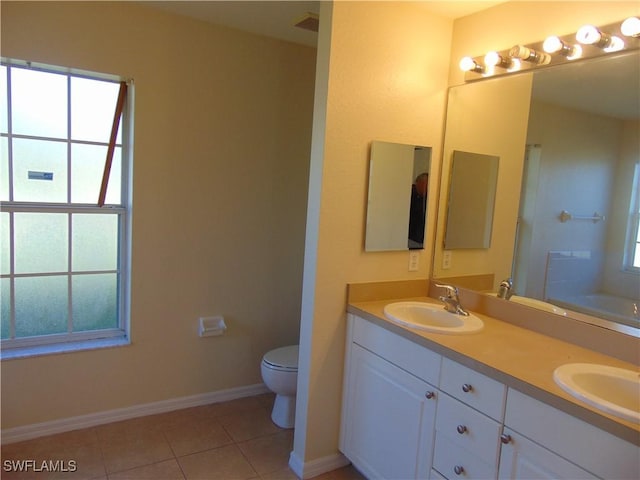 full bath with a healthy amount of sunlight, a sink, and tile patterned floors