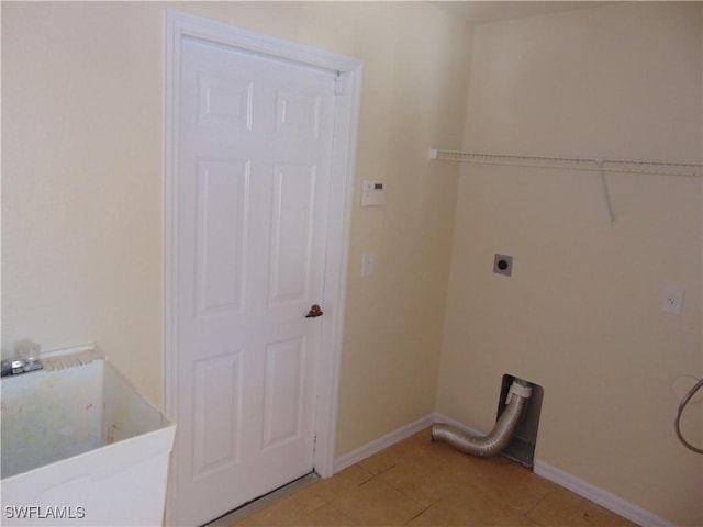 washroom featuring laundry area, light tile patterned floors, baseboards, and hookup for an electric dryer