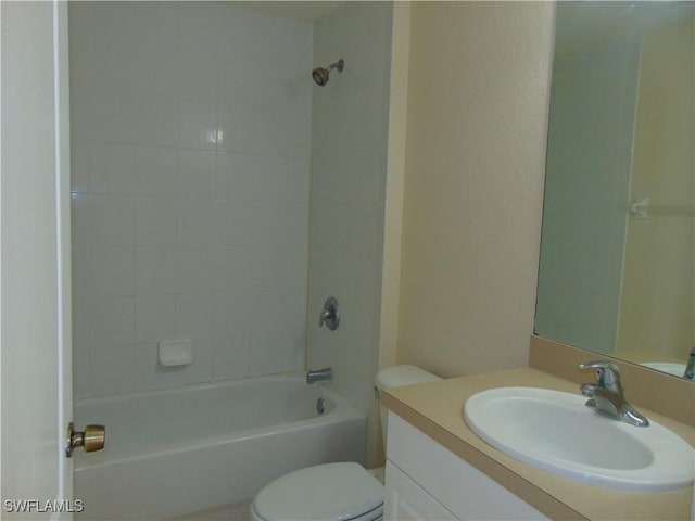 bathroom featuring bathtub / shower combination, vanity, and toilet