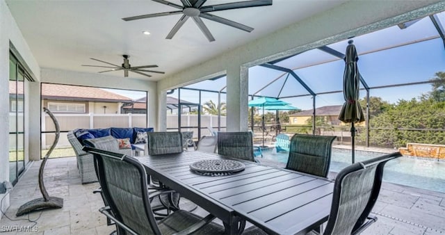 view of patio / terrace with outdoor dining area, a lanai, a fenced in pool, and a ceiling fan