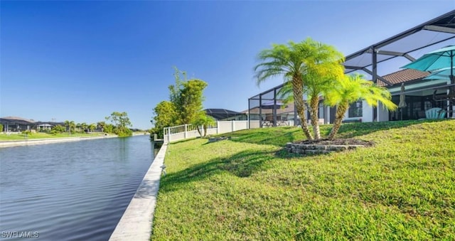 view of yard featuring glass enclosure, a dock, and a water view